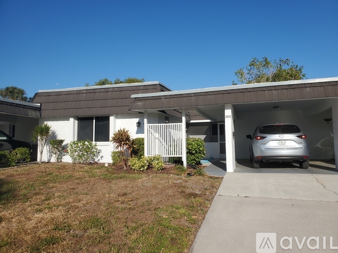 A house with a car in the garage.