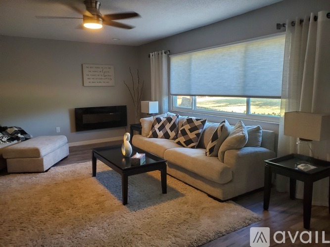 A living room with a fireplace, couch, and coffee table.