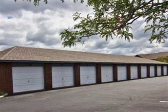 a row of white garage doors on a building