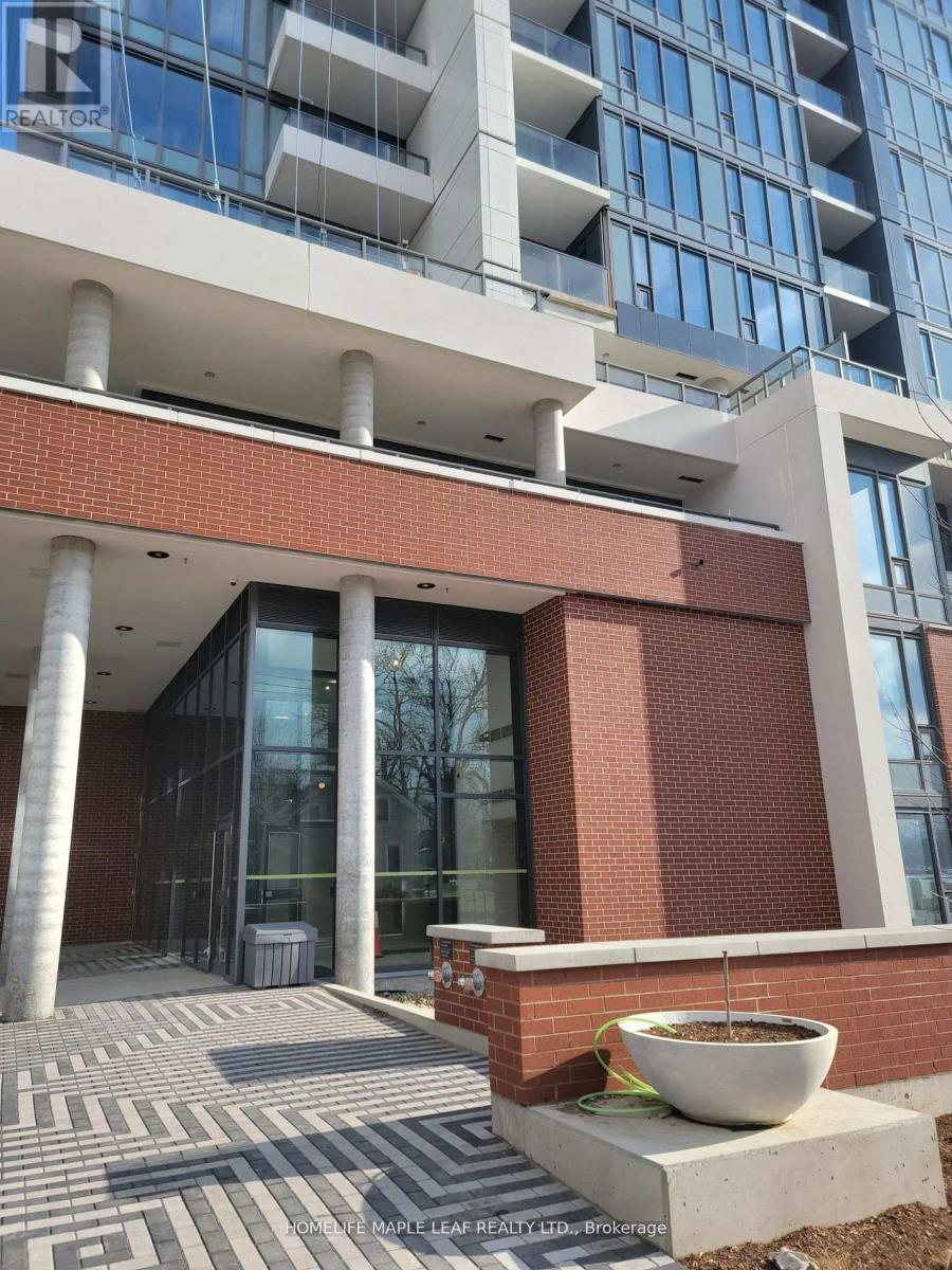 A building entrance with a large planter in front.