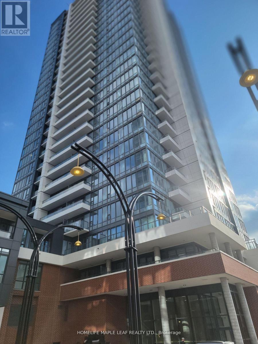 A tall building with a glass facade and a street lamp in front of it.