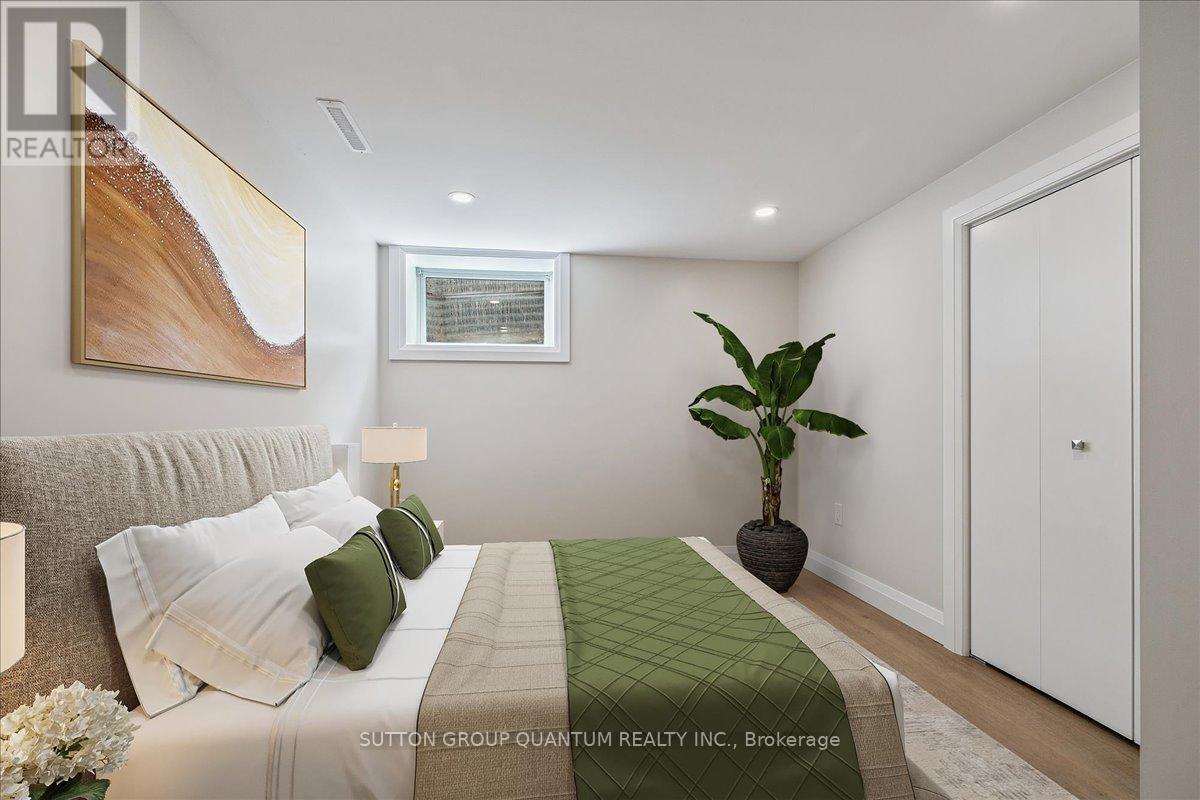 A bedroom with a bed, a lamp, a plant, and a painting on the wall.