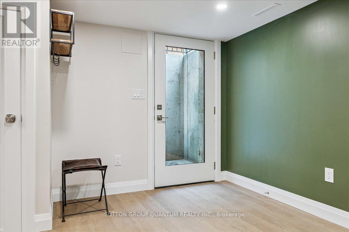 A room with a green wall and a white door.