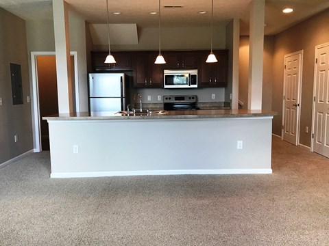 a kitchen with a large counter in the middle of a room