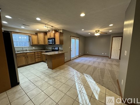 A kitchen with a microwave, oven, and sink is available for rent.