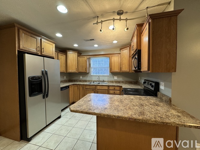A kitchen with granite countertops and stainless steel appliances.