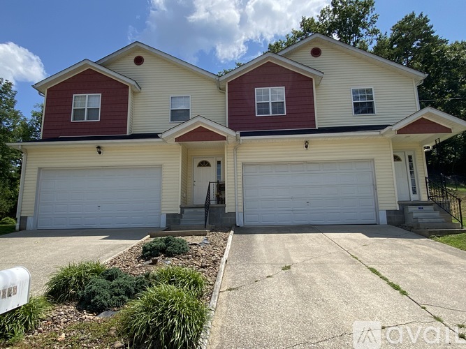 A two-story house with a red and beige exterior.