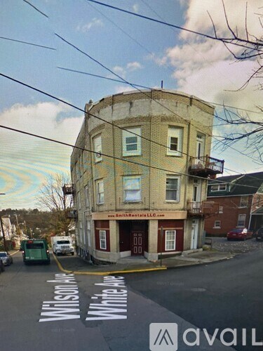 A street view of a building with the words "Wilson St" painted on the road.
