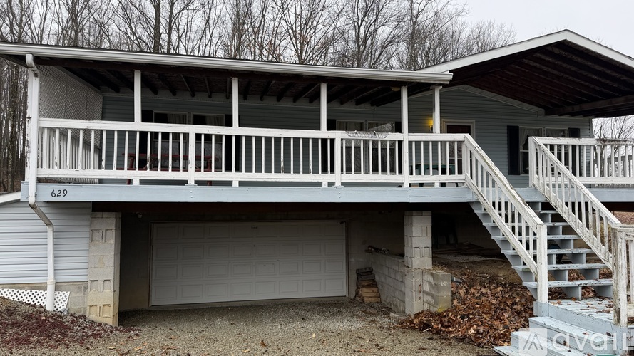 A two-story house with a white porch and a garage.
