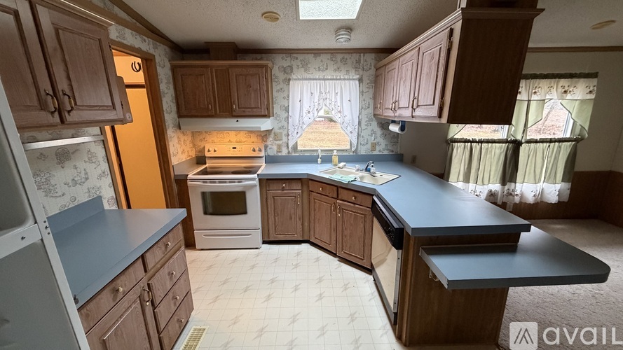 A kitchen with wooden cabinets and a black countertop.