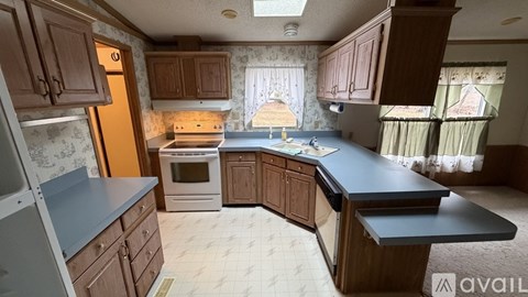 A kitchen with wooden cabinets and a black countertop.