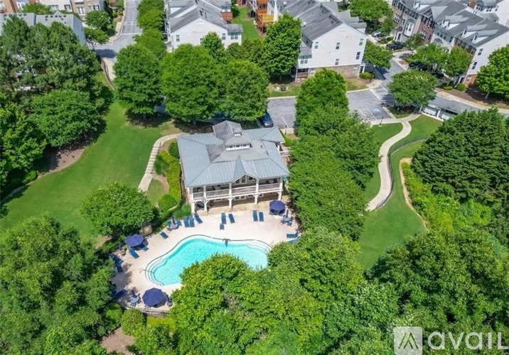 A bird's eye view of a house with a pool and a gazebo.