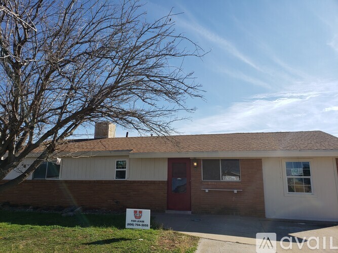 A house with a For Sale sign in front of it.
