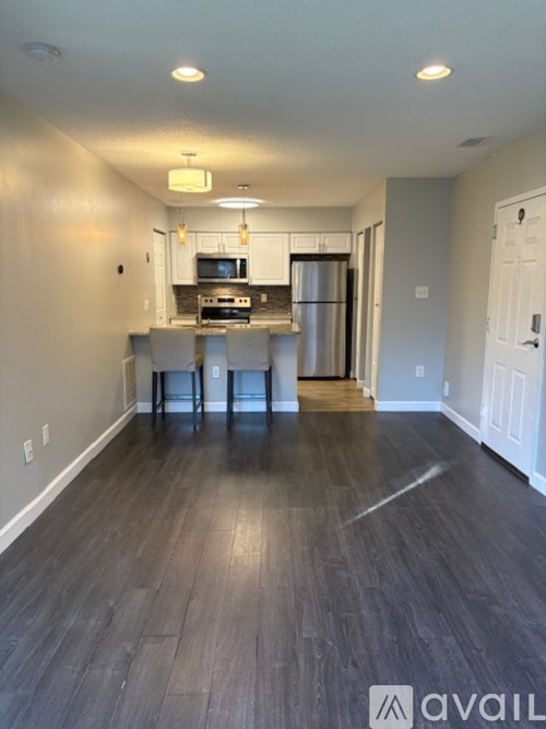 A kitchen with a refrigerator, stove, and oven.