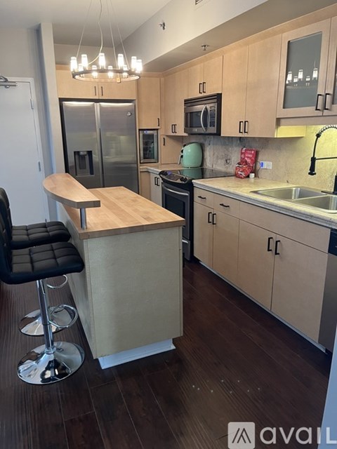 A kitchen with a table and chairs.