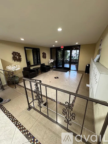 A spacious foyer with a staircase leading to the upper floor.