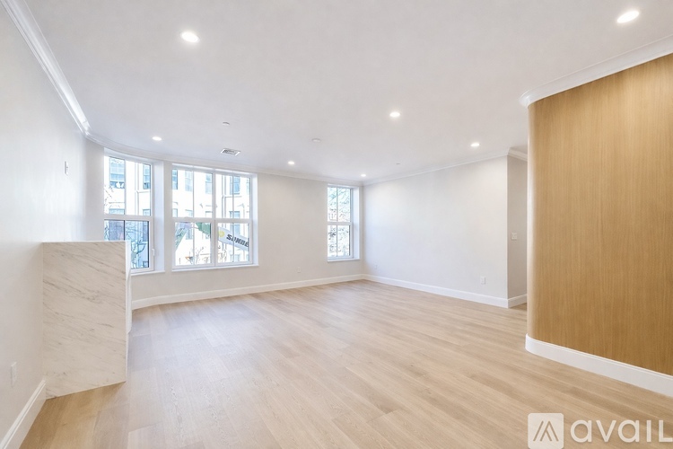 A modern dining room with a wooden table and chairs.