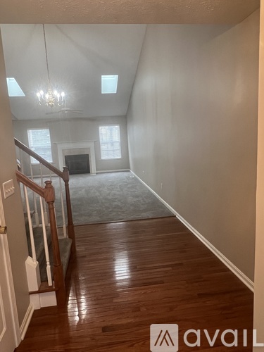 A room with wooden floors and a chandelier.
