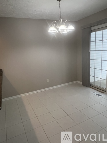 A room with a light fixture and a window.