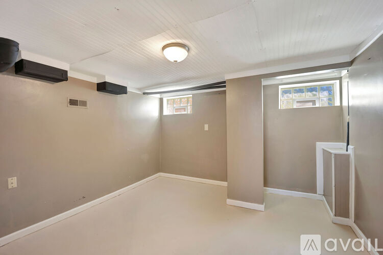 A room with a window and a door is available for rent.