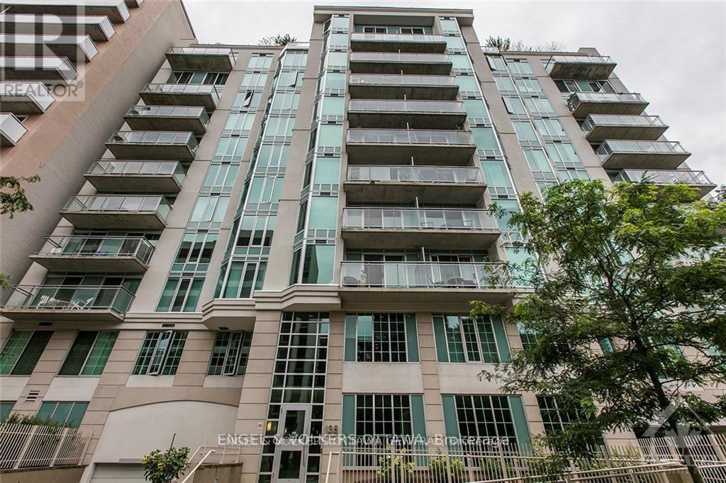 A tall building with many windows and balconies is shown.