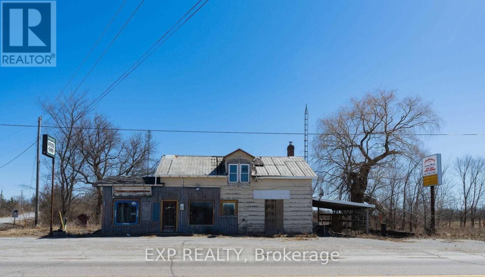 An abandoned building sits in the middle of a desolate area.