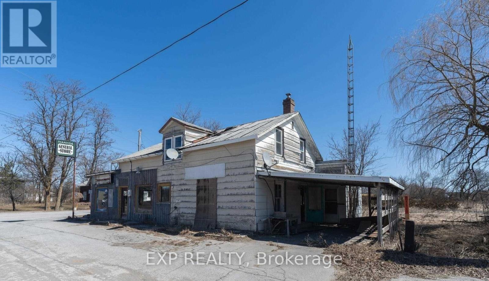An old house with a sign that says EXP REALTY Brokerage.