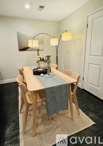 A dining room with a table set for two.