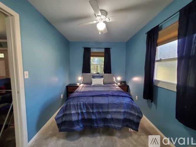 A bedroom with a bed and a window.