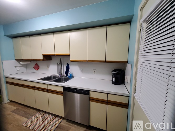 A kitchen with a sink and a dishwasher.