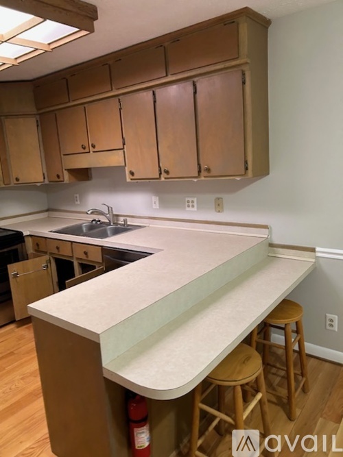 A kitchen with wooden cabinets and a white countertop.