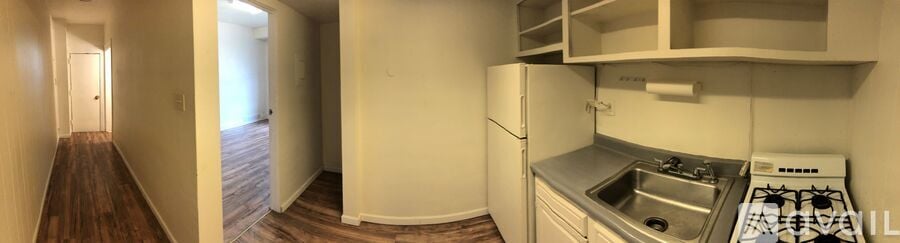 A kitchen with a stove top oven and a sink.