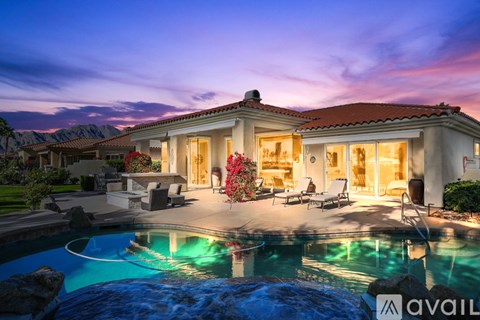 A house with a pool in front of it is available for sale.