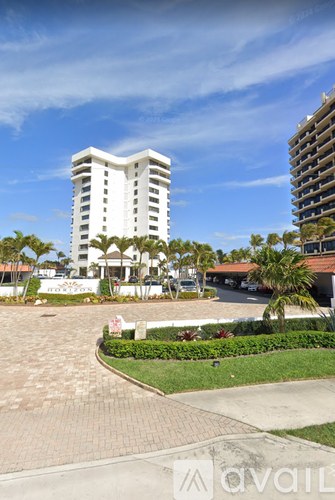 A white building with a red and white striped sign in front of it.
