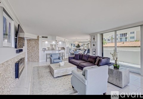A spacious living room with a grey sofa and a coffee table.