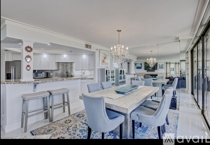 A modern dining room with a large table and chairs.