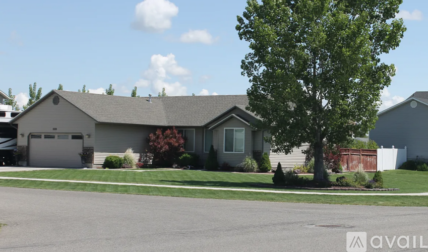 A house with a tree in front of it.