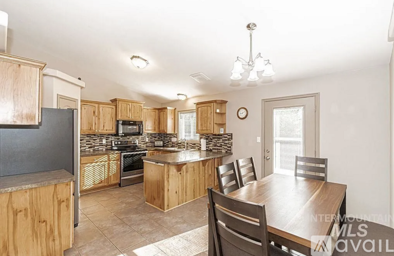 A kitchen with wooden cabinets and a granite countertop.