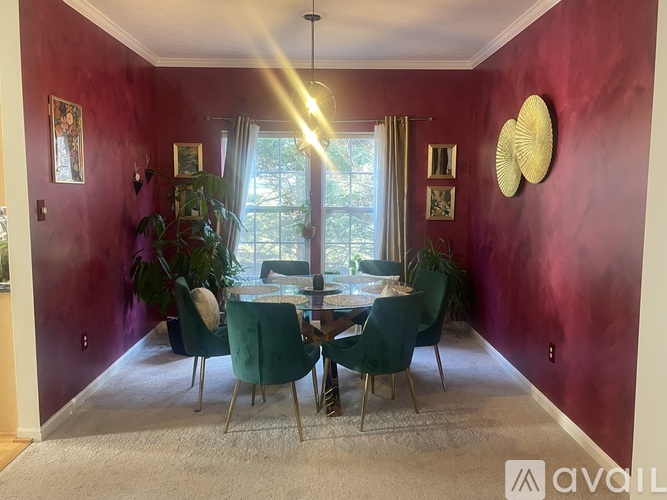 A dining room with a table set for four and a large window.