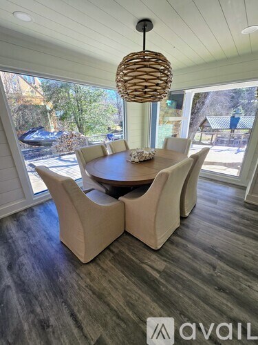 A modern dining room with a round table and chairs.
