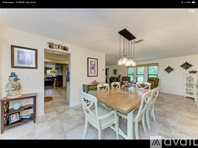 A dining room with a wooden table and chairs.