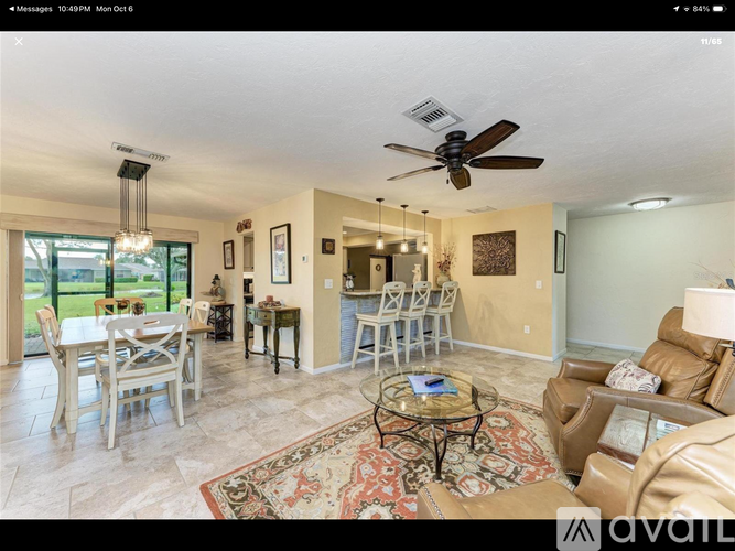A living room with a dining table and chairs.
