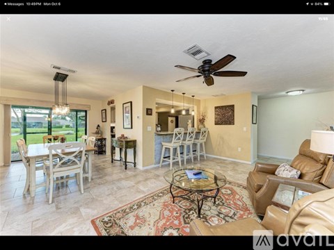 A living room with a dining table and chairs.
