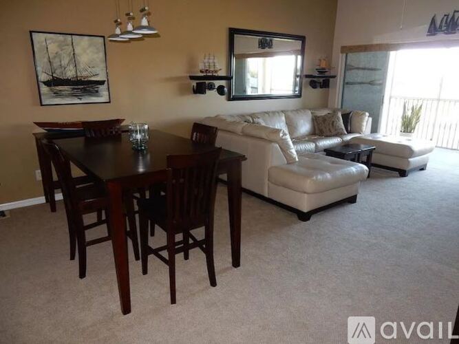 A living room with a dining table and chairs.