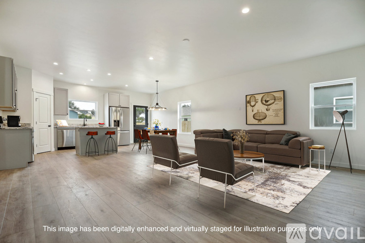A modern living room with a brown sofa and a grey rug.