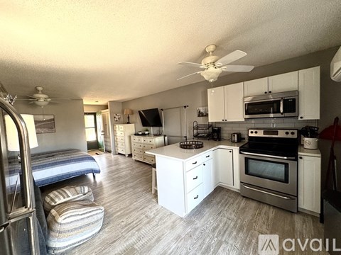 A kitchen with white cabinets and a stainless steel oven.