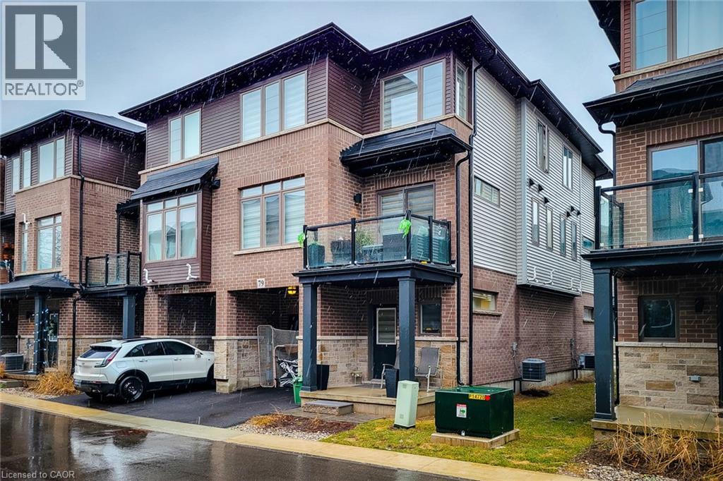 A row of houses with a car parked in front of them.