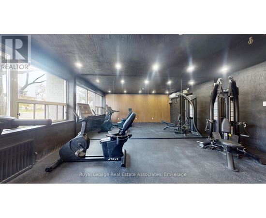 A gym with a variety of equipment including treadmills, weights and exercise machines.