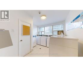 A white laundry room with a washer and dryer.