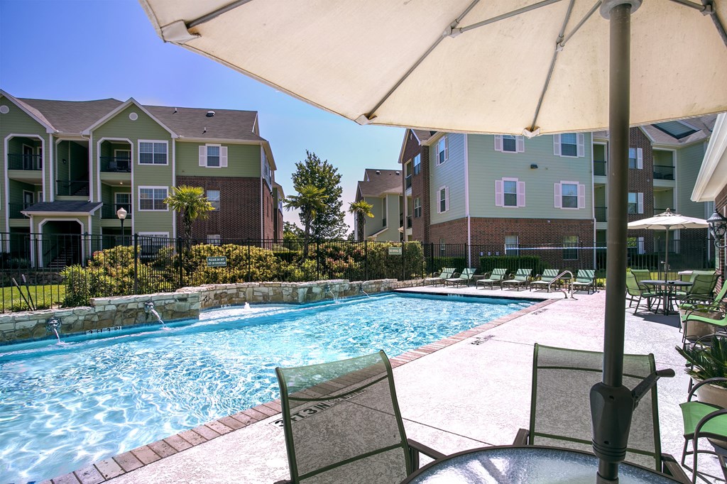 our apartments have a large pool with chairs and umbrellas